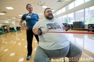 Obese man exercising. Overweight retired school bus driver in an exercise class at a health and fitness centre near his home in Knoxville, Tennessee, USA. From the book 'What I Eat: Around the World in 80 Diets' by Peter Menzel and Faith D'Aluisio.